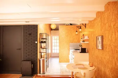 a kitchen with a table and a brick wall at Beach House Sea La Vie 50 meters from the beach in Zandvoort