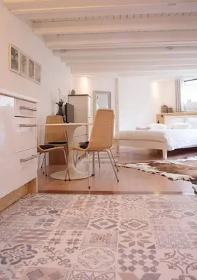 a room with a desk and chairs and a bed at Beach House Sea La Vie 50 meters from the beach in Zandvoort