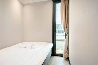 a bed in a room with a large window at Moderne houseboat op het water! in Assendelft