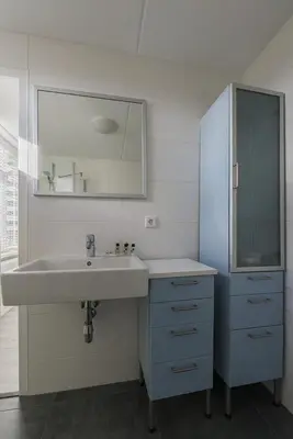 a bathroom with a sink and a mirror at Strand 122 Appartement in Egmond aan Zee