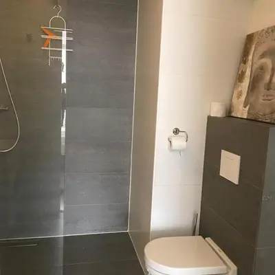 a bathroom with a shower and a toilet at Strand 122 Appartement in Egmond aan Zee