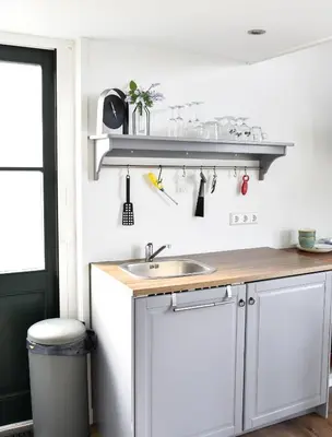 a kitchen with a sink and a counter at Pronkhuisje in Oterleek