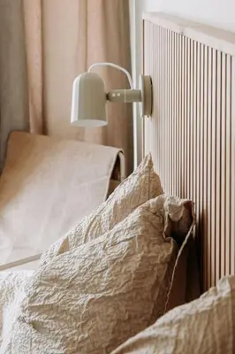 a bedroom with a bed with a lamp on it at Etoile31 seaside apartment Egmond aan Zee in Egmond aan Zee