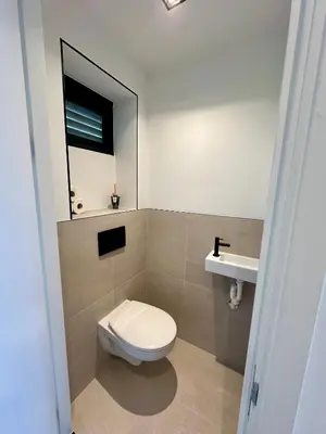 a bathroom with a toilet and a sink at Eight in Zandvoort