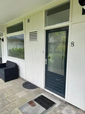 a front door of a house with a black door at Eight in Zandvoort