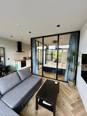 a living room with a couch and a table at Eight in Zandvoort