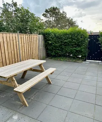 a wooden picnic bench sitting on a patio at Eight in Zandvoort