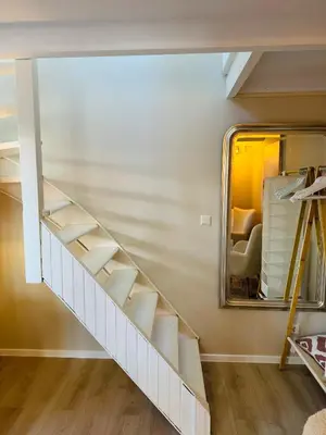 a staircase in a room with a mirror at Cosy summerhouse in Noordwijk aan Zee