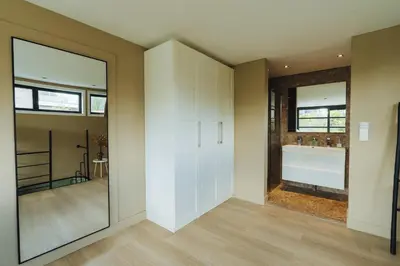 a pivot door in a bathroom with a view of a sink at Sfeervol luxe appartement Haarlemmerhout bij Haarlem Centrum en Amsterdam - gratis parkeren in Haarlem