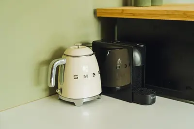 a coffee maker sitting on a counter next to a toaster at Sfeervol luxe appartement Haarlemmerhout bij Haarlem Centrum en Amsterdam - gratis parkeren in Haarlem