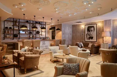 a salon with chairs and tables and a waiting room at Hotel Heer Hugo in Heerhugowaard