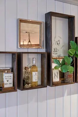 a shelf with a bottle of whiskey and a mirror at Hotel Heer Hugo in Heerhugowaard