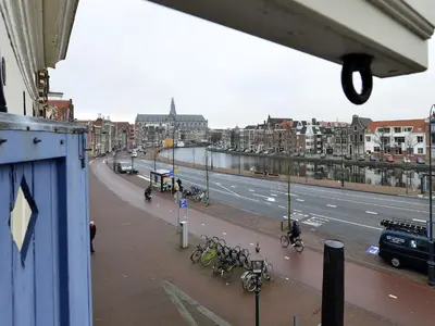 a view of a city street with bikes parked on a sidewalk at Turfhuys aan het Spaarne in Haarlem