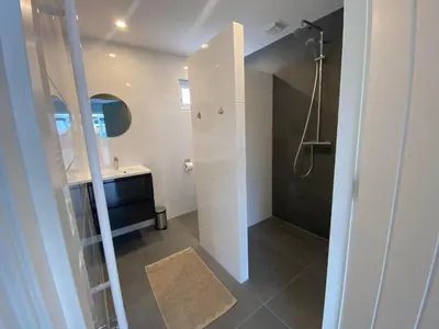 a bathroom with a shower and a sink at Miles in Egmond aan Zee