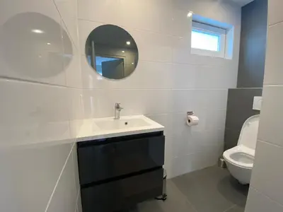 a bathroom with a sink and a toilet at Miles in Egmond aan Zee