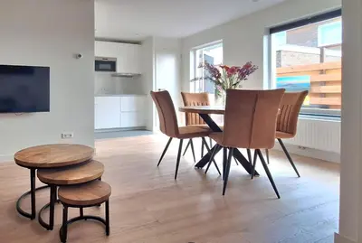 a kitchen and dining room with a table and chairs at Miles in Egmond aan Zee