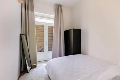 a bedroom with a bed and a window at Stylish apartment next to the Amstel river- Unit D in Amsterdam