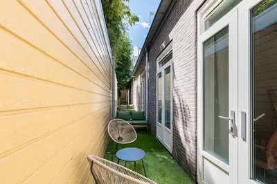 a small patio with a table and chairs on the side of a building at Stylish apartment next to the Amstel river- Unit D in Amsterdam
