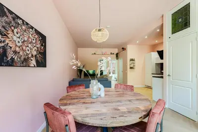 a kitchen and dining room with a wooden table and chairs at Stylish apartment next to the Amstel river- Unit F in Amsterdam