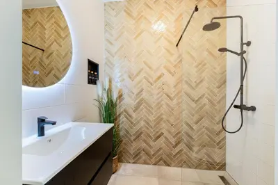 a bathroom with a sink and a shower at Stylish apartment next to the Amstel river- Unit F in Amsterdam