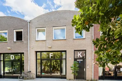 a brick building with a bike parked in front of it at Stylish apartment next to the Amstel river- Unit F in Amsterdam