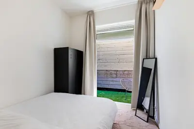 a bedroom with a bed and a window at Stylish apartment next to the Amstel river- Unit F in Amsterdam