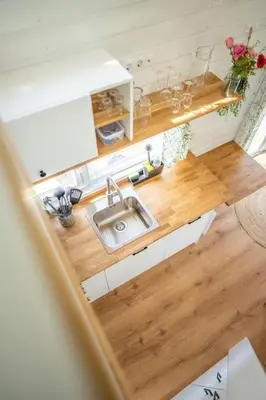 an overhead view of a kitchen with a sink at Yellow Tiny House with shared pool in Zeewolde