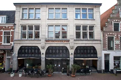 a large building with bikes parked in front of it at Bed & Breakfast Hotel Malts in Haarlem