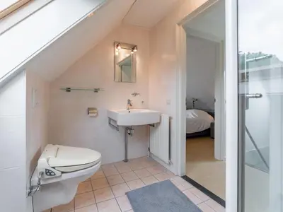 a bathroom with a toilet and a sink at Schoorlse Duinvoet in Schoorl