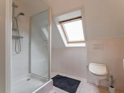 a bathroom with a shower and a toilet at Schoorlse Duinvoet in Schoorl
