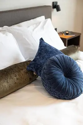 a bed with two pillows on top of it at Hotel Twenty-Three Amsterdam Airport in Hoofddorp