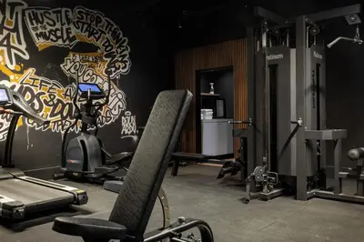 a room with a gym with a wall at Hotel Twenty-Three Amsterdam Airport in Hoofddorp