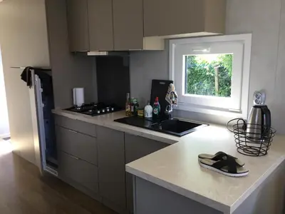 a kitchen with a stove and a counter top at Chalet Buitenhof 45A in Oegstgeest