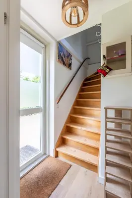 a staircase in a home with a window at Beautifully located dune villa near Noordwijk beach in Noordwijk