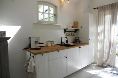 a kitchen with white cabinets and a counter top at Casa Fiore in Bergen