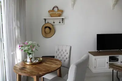 a living room with a table and a television at Casa Fiore in Bergen
