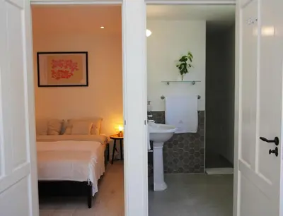 a bedroom with a bed and a sink and a bathroom at Casa Fiore in Bergen