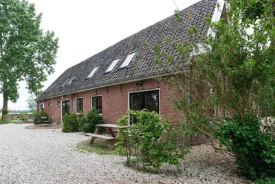 a brick building with a picnic table in front of it at Beautiful House in The Middle of Nature in Abcoude