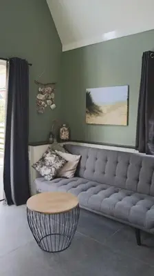 a living room with a couch and a table at Have a nice stay! - Trendy Vakantiehuis Carpe Diem met eigen tuin in Noordwijk