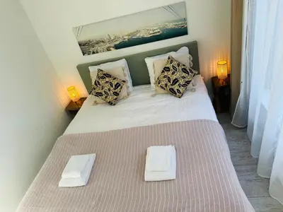 a bedroom with a bed with two towels on it at Perfectly located charming apartment MAGDALENA HOUSE for true connoisseurs in Haarlem