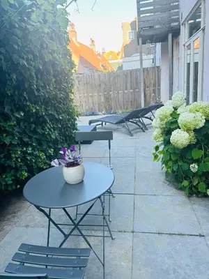 a patio with tables and chairs and plants at Perfectly located charming apartment MAGDALENA HOUSE for true connoisseurs in Haarlem