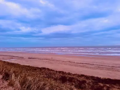 a beach with the ocean on a cloudy day at Perfectly located charming apartment MAGDALENA HOUSE for true connoisseurs in Haarlem