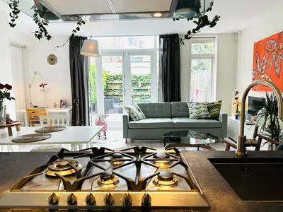 a kitchen and living room with a stove top at Perfectly located charming apartment MAGDALENA HOUSE for true connoisseurs in Haarlem