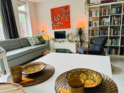 a living room with a couch and a table at Perfectly located charming apartment MAGDALENA HOUSE for true connoisseurs in Haarlem