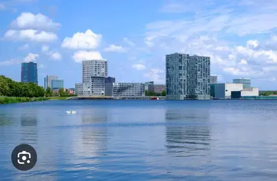 a large body of water with a city in the background at In Almere, Close to Amsterdam in Almere