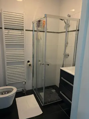 a bathroom with a glass shower and a toilet at In Almere, Close to Amsterdam in Almere