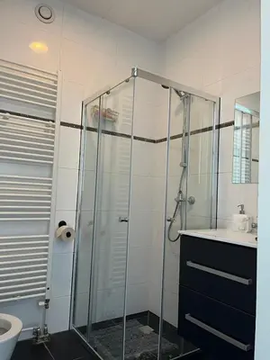 a bathroom with a glass shower and a sink at In Almere, Close to Amsterdam in Almere