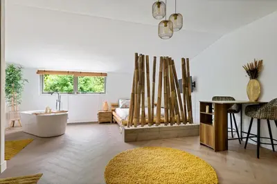 a living room with a couch and a table at Bamboe Suite Bentveld met ligbad en gratis parkeren in Bentveld