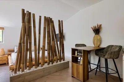 a room with a bunch of wooden bats leaning against a wall at Bamboe Suite Bentveld met ligbad en gratis parkeren in Bentveld