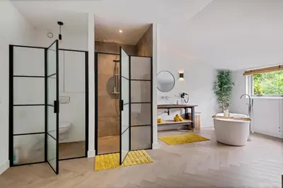 a bathroom with a shower and a tub and a sink at Bamboe Suite Bentveld met ligbad en gratis parkeren in Bentveld